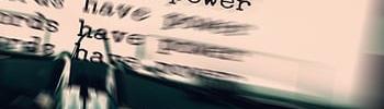 "words have power" having been typed by a typewriter many times on an 8 1/2" by 11" white paper