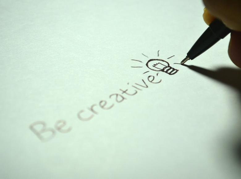 The words "Be creative" with a light bulb 
