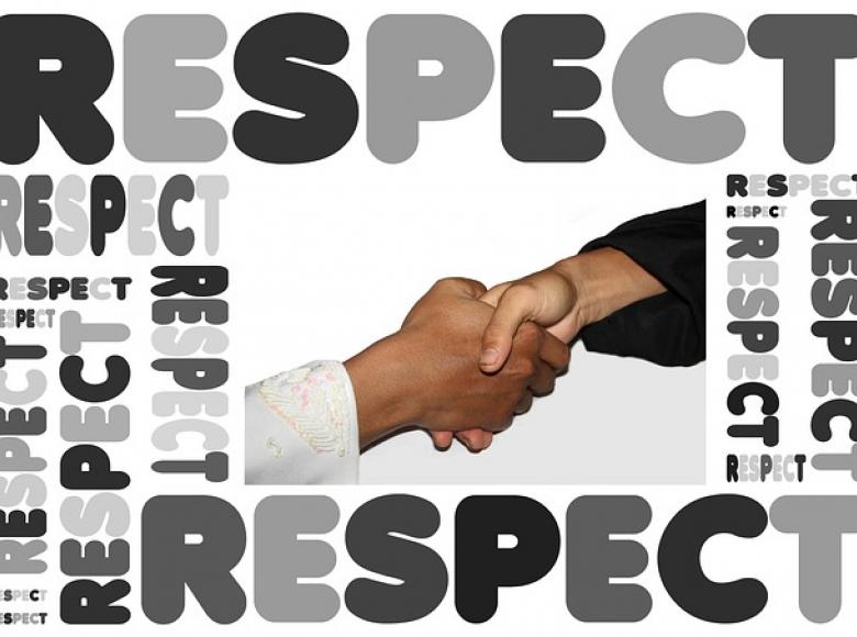 A Black Male and Whit Female shaking hands with the words RESPECT on all four sides of the photo