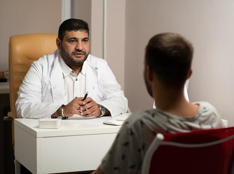 Doctor sitting with a patient and explaining the situation