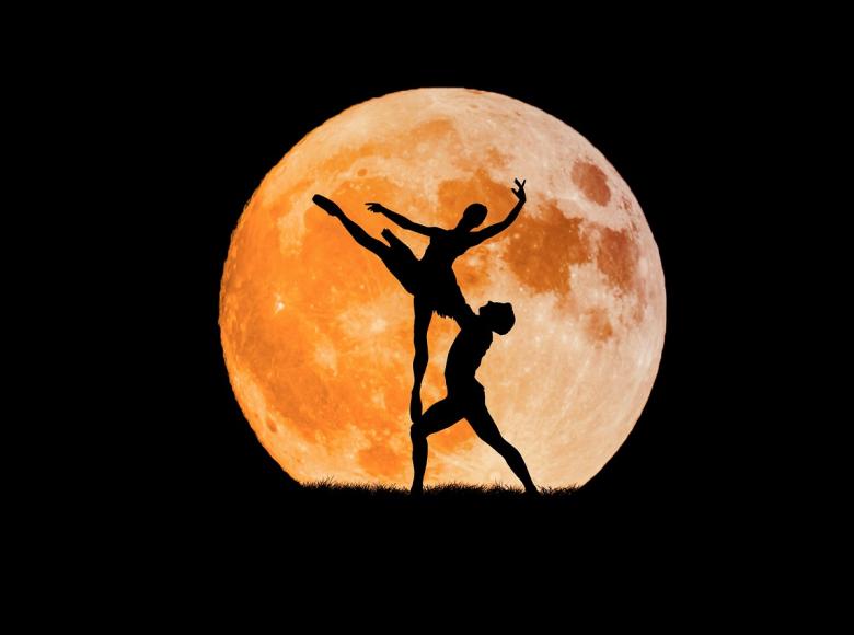 dancing ballet couple in front of the moon