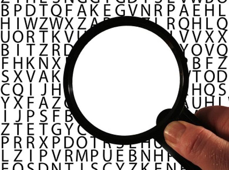 Magnifying glass in hand trying to read something