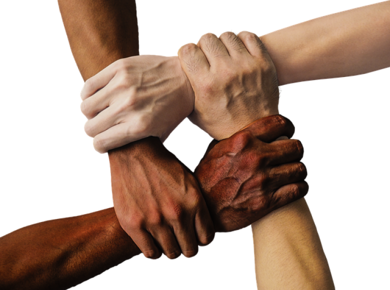 Four diverse colored arms reaching across to hold each others' wrists