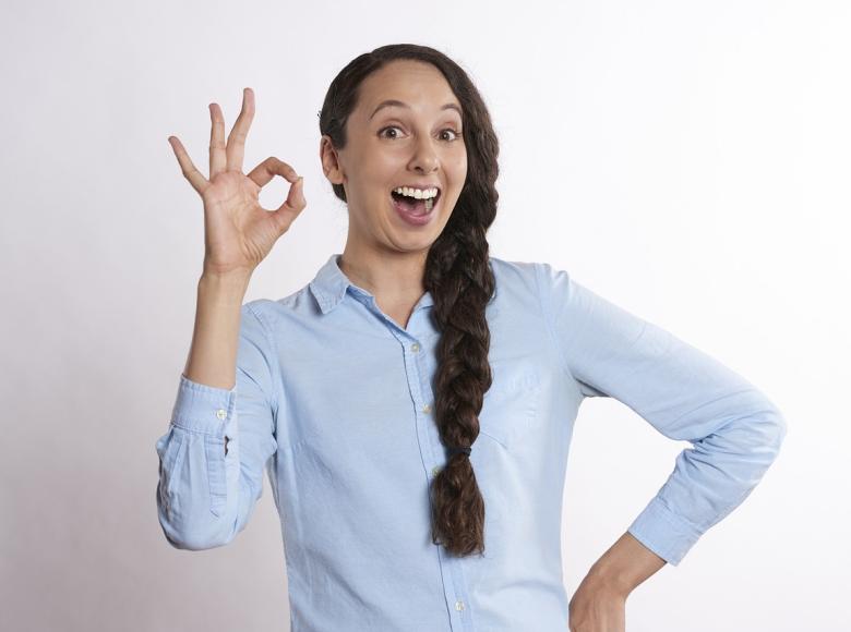 Girl with hand giving "ok" sign