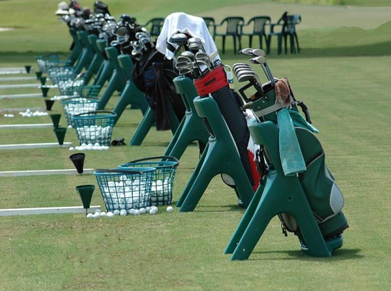 golf clubs set up at the practice range