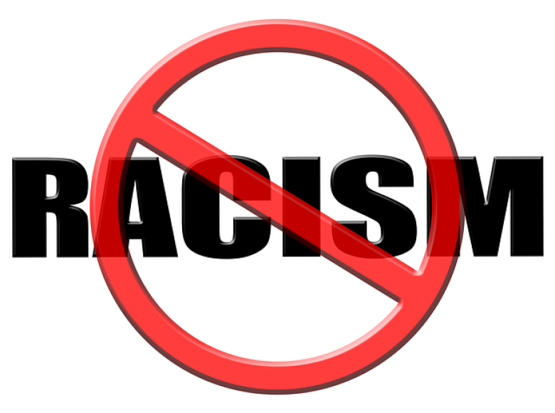 The word RACISM in capital letters and a red international not symbol in front of it